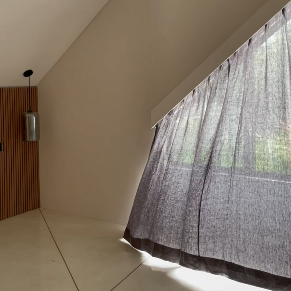 Charcoal sheer curtain in an attic room