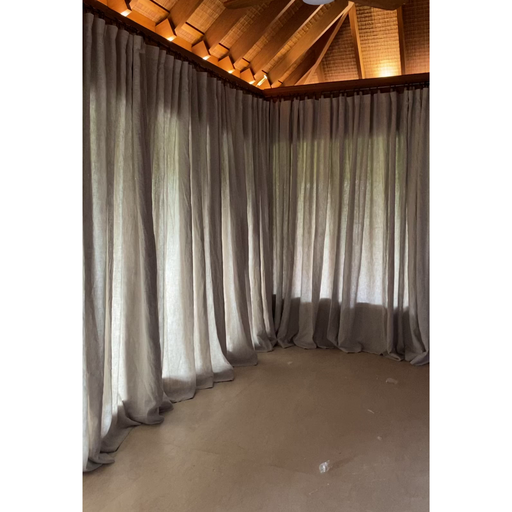 Fog and charcoal curtains under a joglo roof