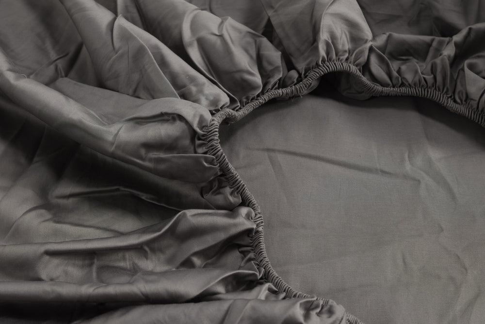 Ash grey Egyptian long-staple organic cotton fitted sheet on a mattress