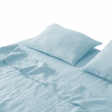 Light blue bedding set with two pillows on a white background