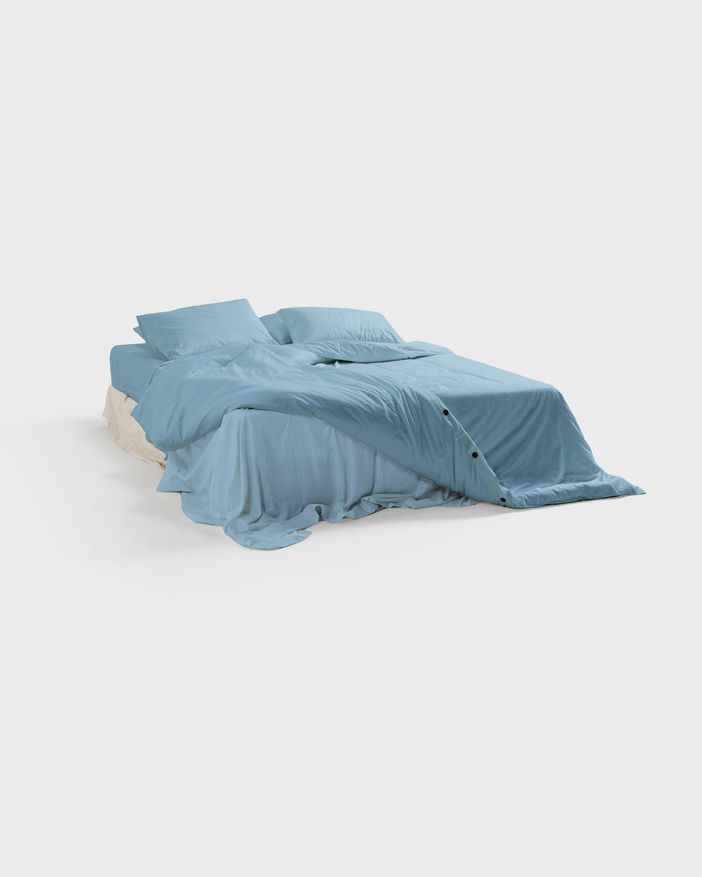 Sky organic cotton sateen duvet cover on a made bed