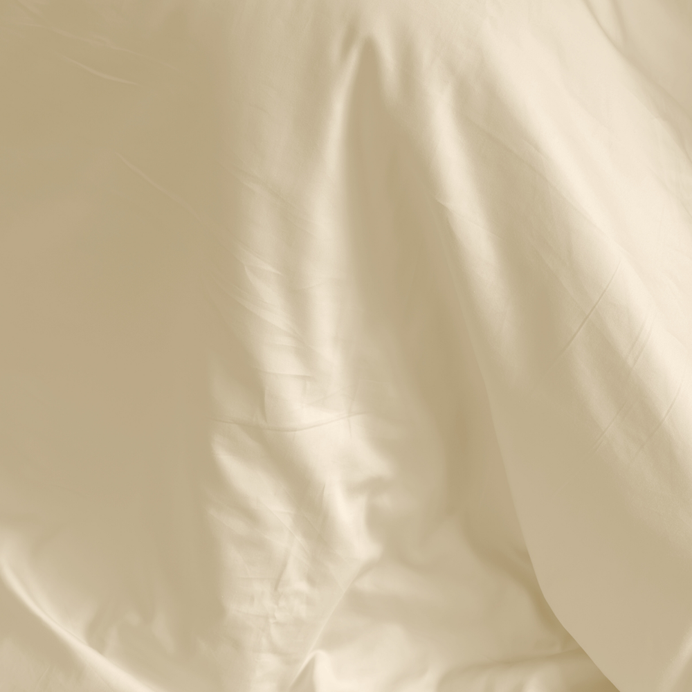 Close-up of ivory organic cotton sateen with its soft sheen