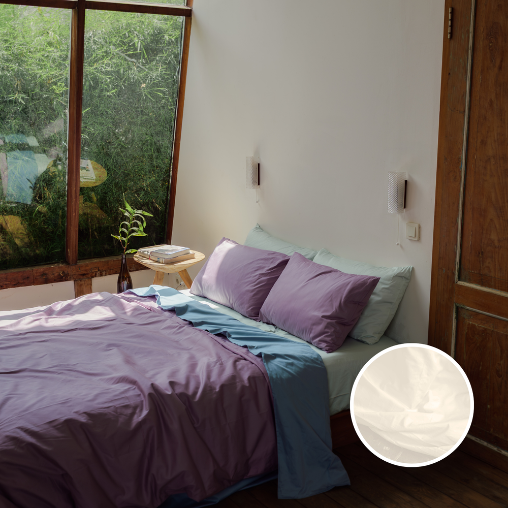 Organic cotton sateen sheets and pillowcases on a styled bed, with a close-up of the white fabric